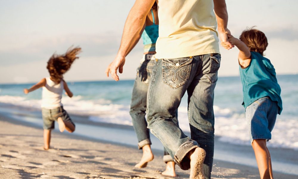 Family running on beach