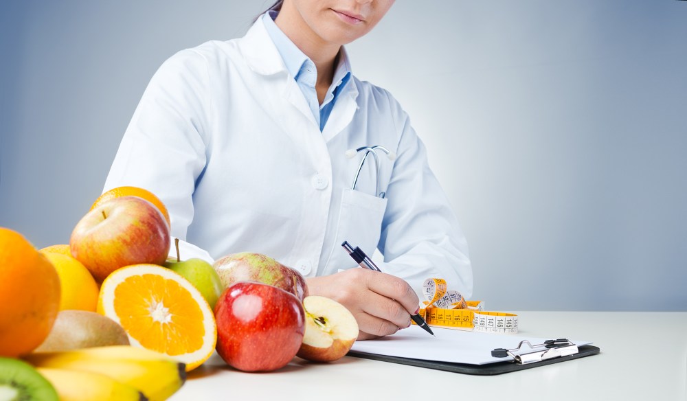 Professional nutritionist writing medical records