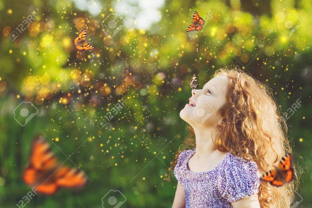Cute child girl with a butterfly on his nose