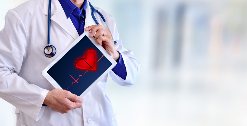 Doctor showing tablet with electrocardiogram representation concept